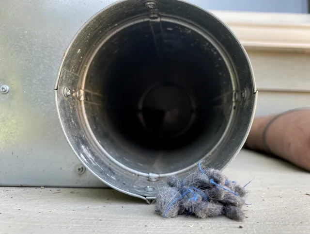 New Fairfield Dryer Vent Cleaning technician using specialized equipment to clear severe dryer vent blockage in New Fairfield
